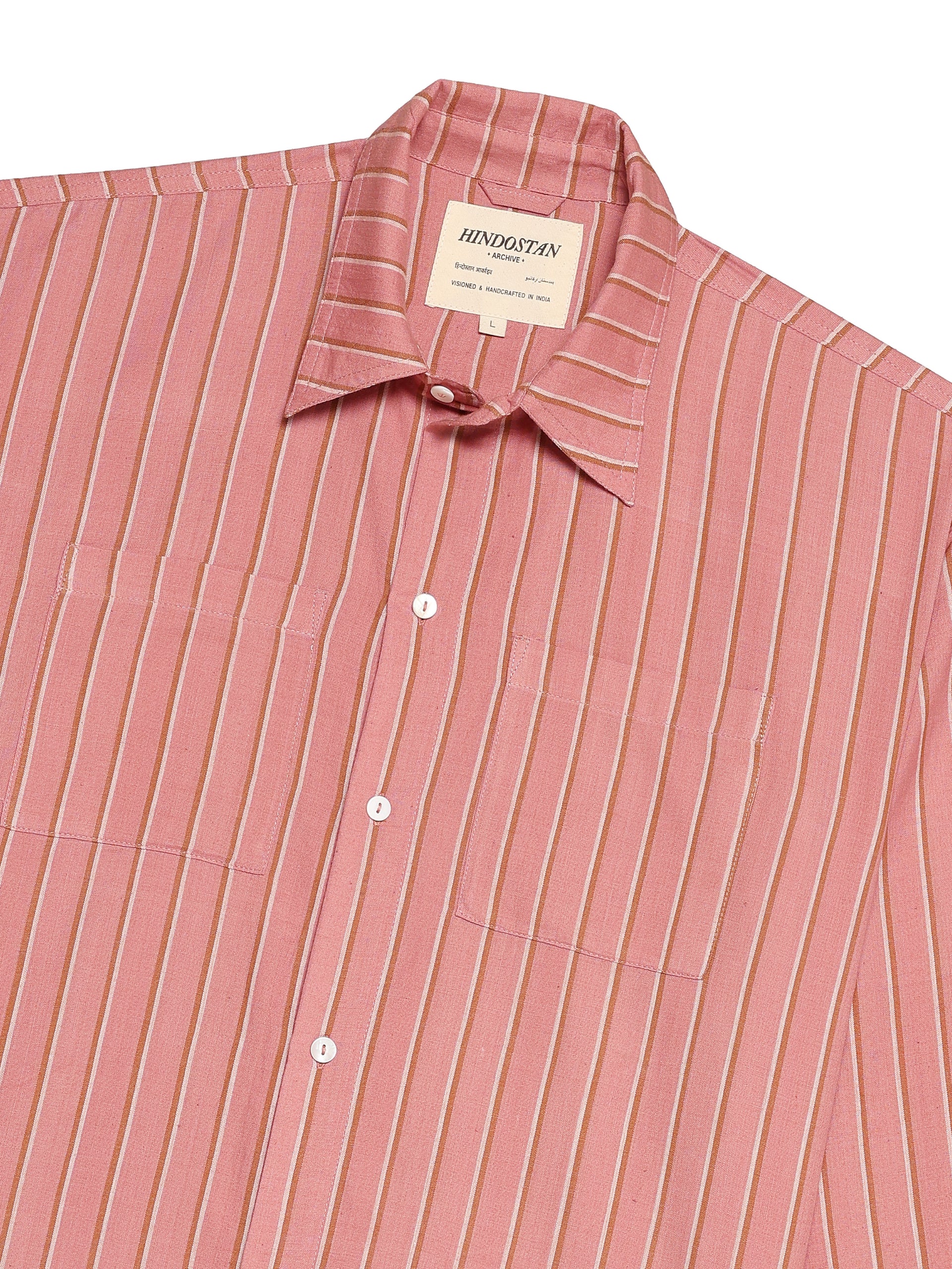 Pink striped shirt with a brand label on a white background