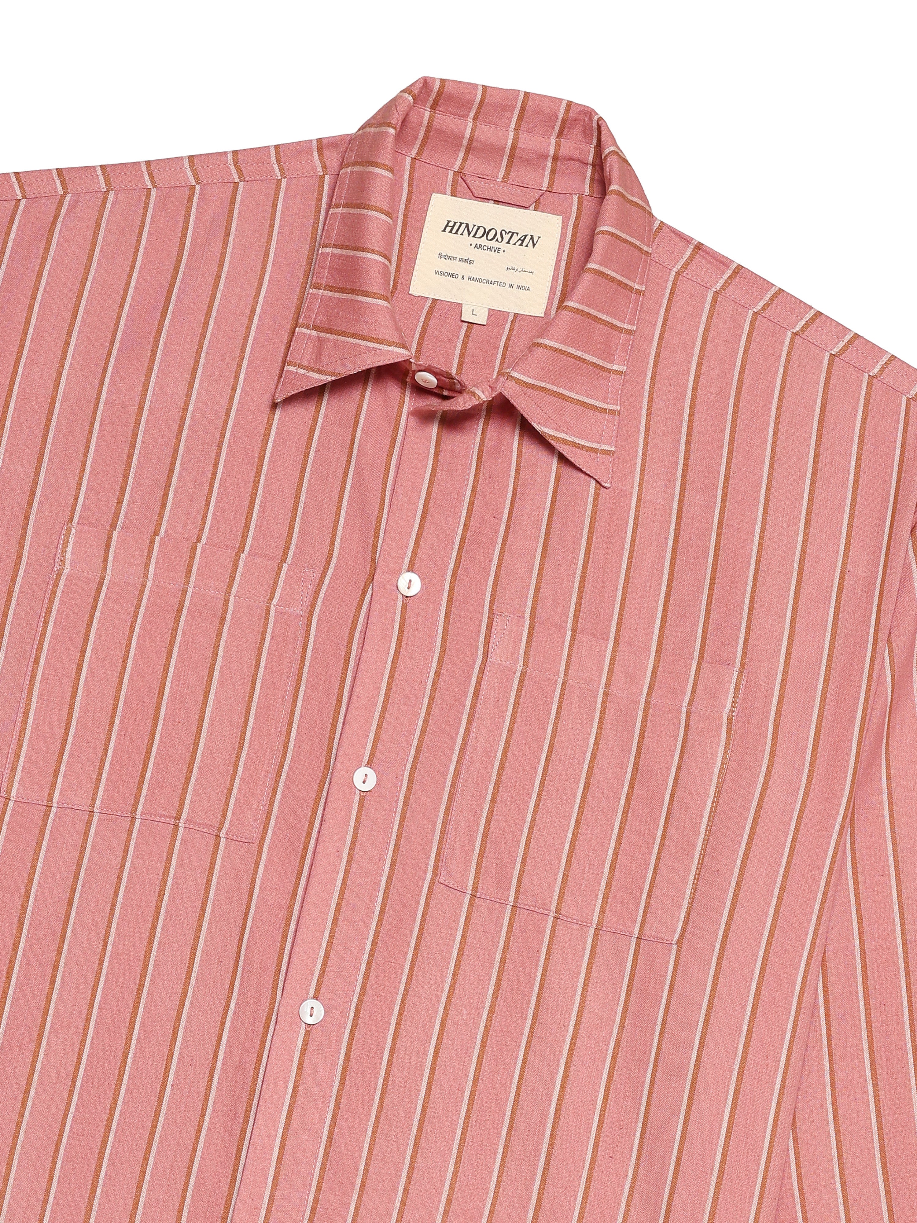 Pink striped shirt with a brand label on a white background