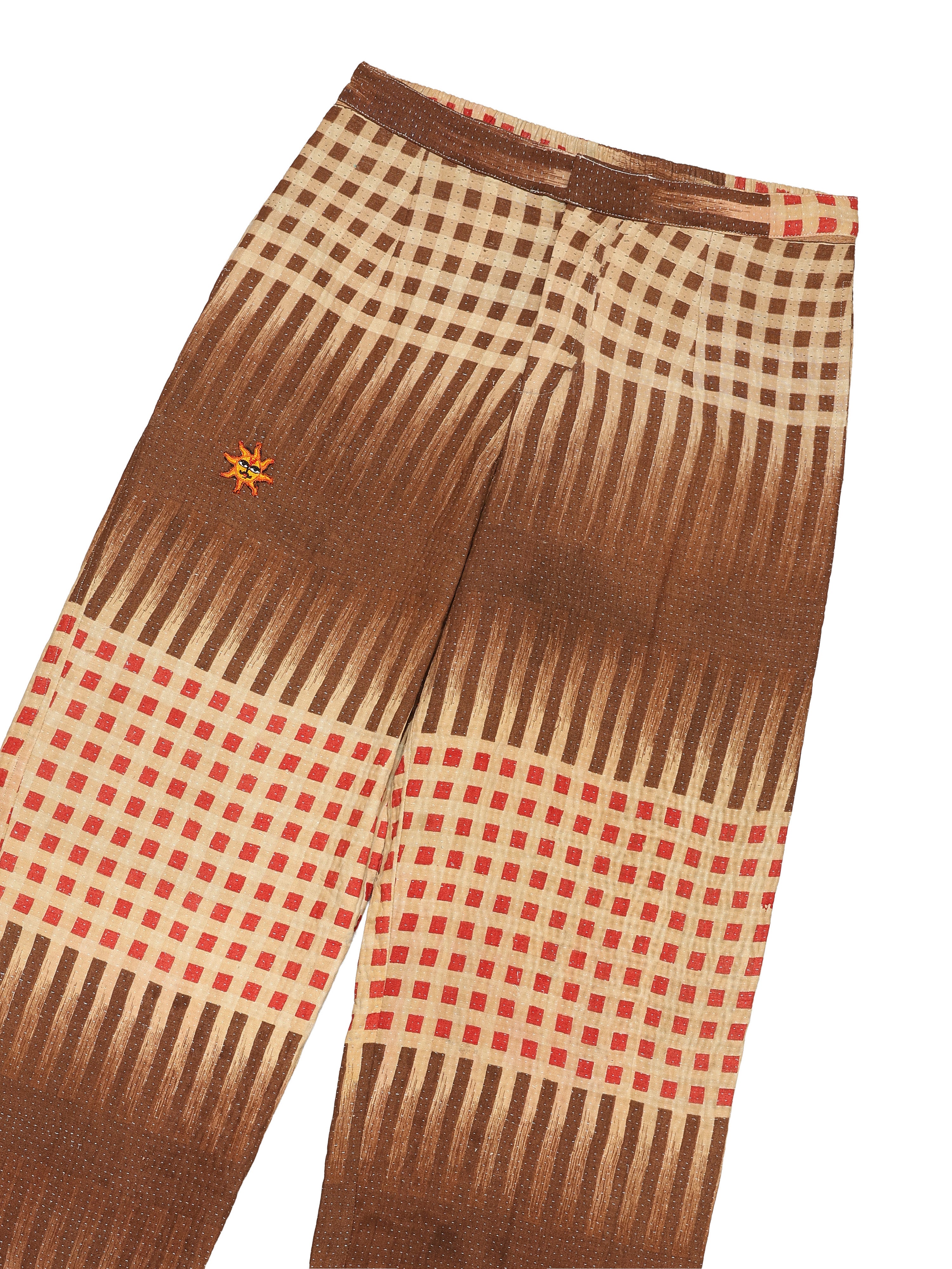 Brown and beige checkered pants with a small logo on a white background