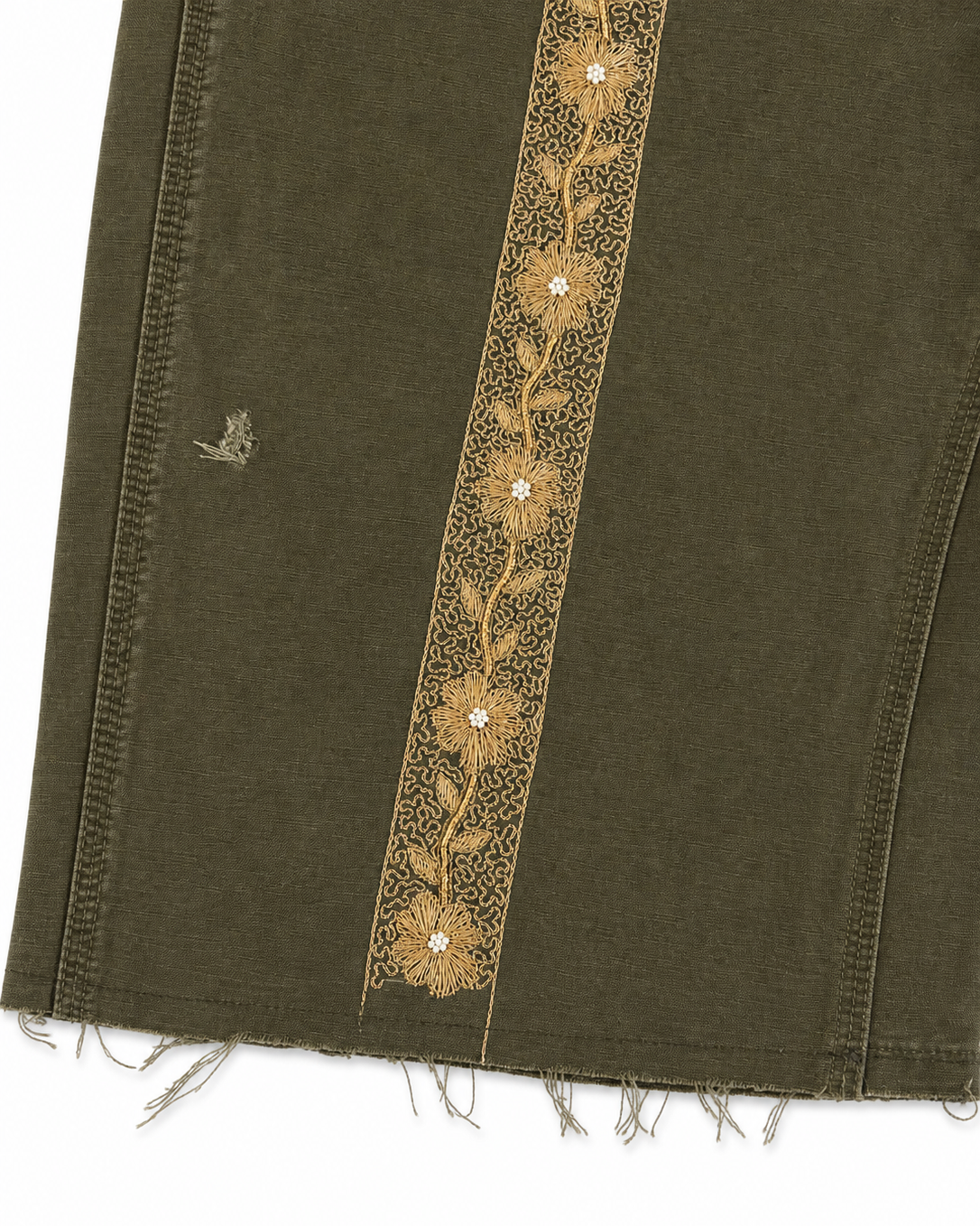 Green fabric with gold embroidery on a white background