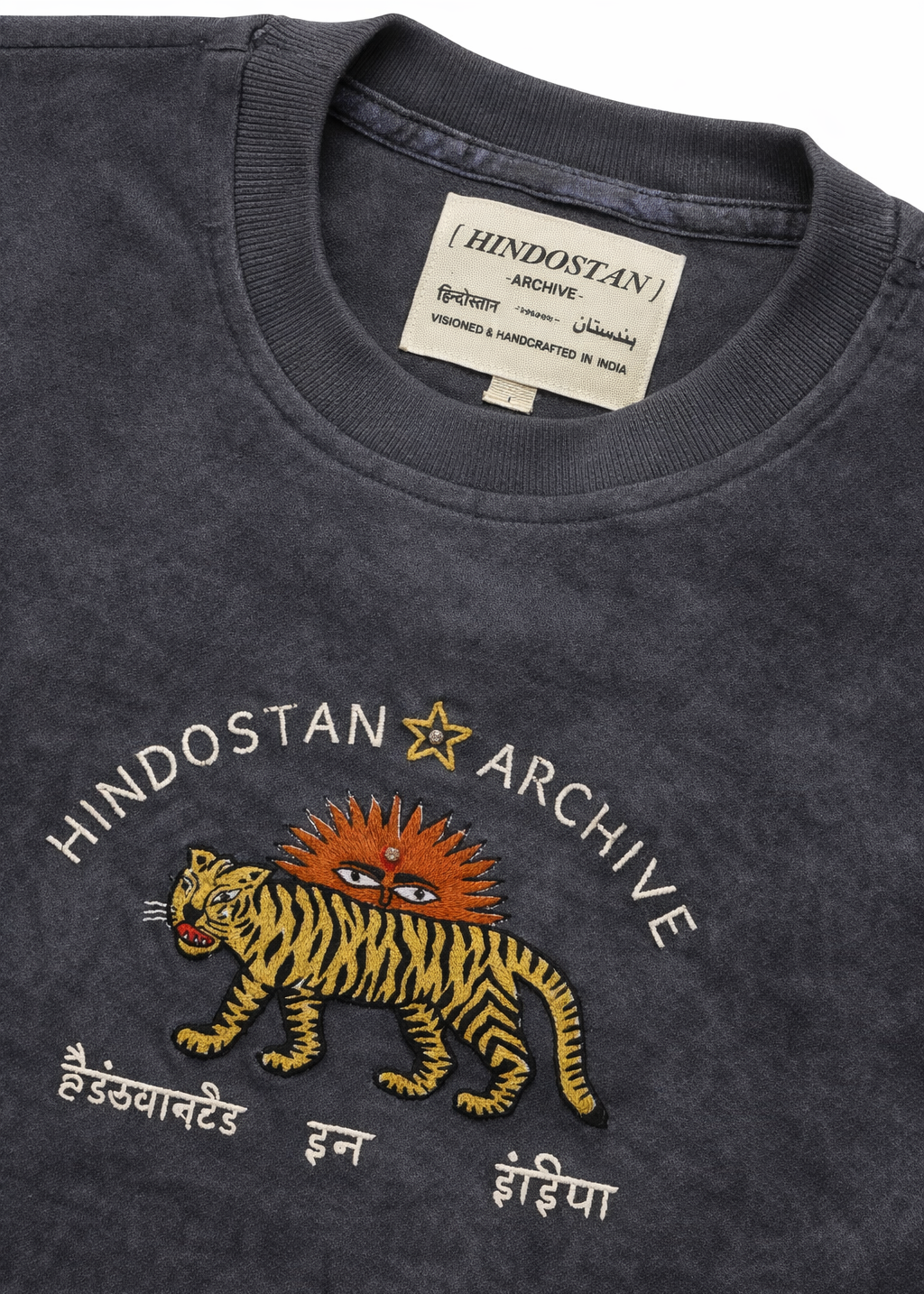 Dark gray t-shirt with a tiger graphic and 'Hindostan Archive' text on a plain background