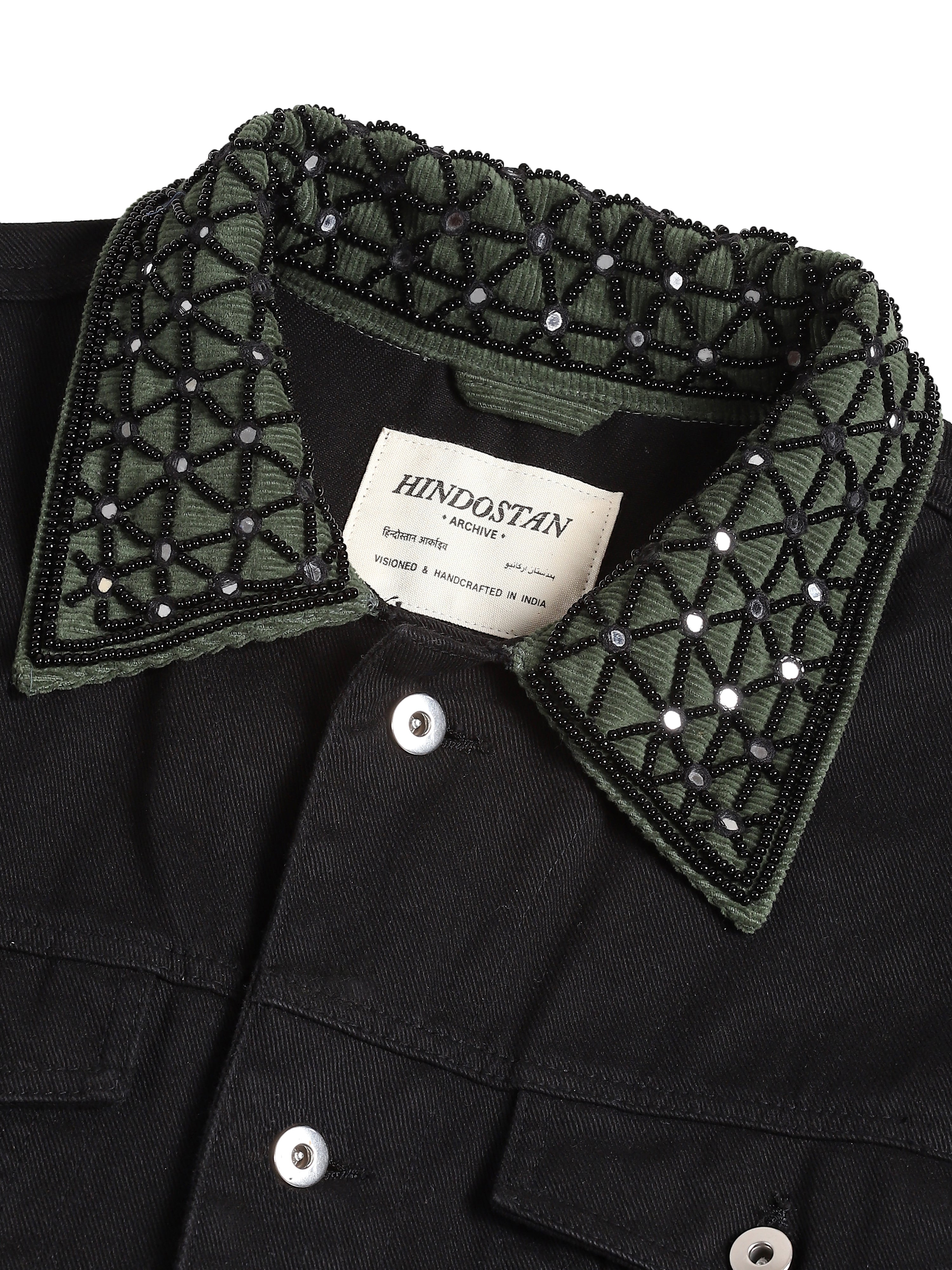 Black denim jacket hand-embroidered collar close-up with Hindostan Archive label – artisan menswear natural dyed clothing
