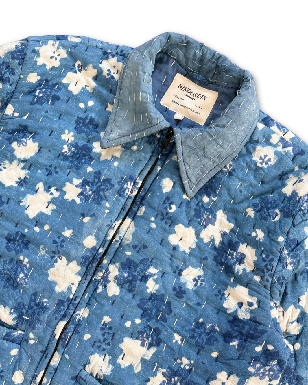 Collar detail of INDIGO Kantha quilted jacket showing white floral Dabu print and hand-stitching – Hindostan Archive