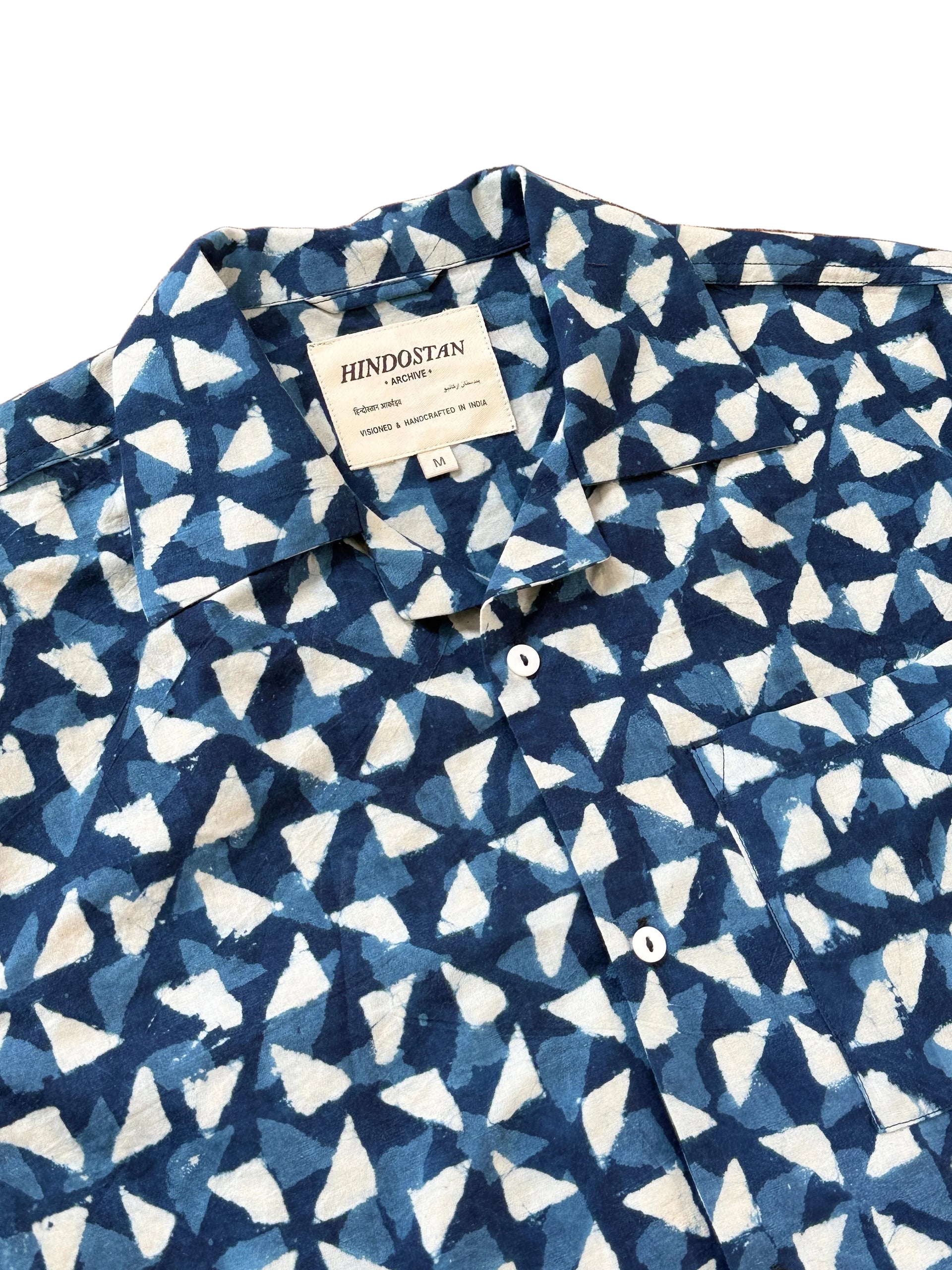 Collar and label detail of Trikon indigo Ajrakh hand block printed natural dyed camp shirt – Hindostan Archive artisan menswear